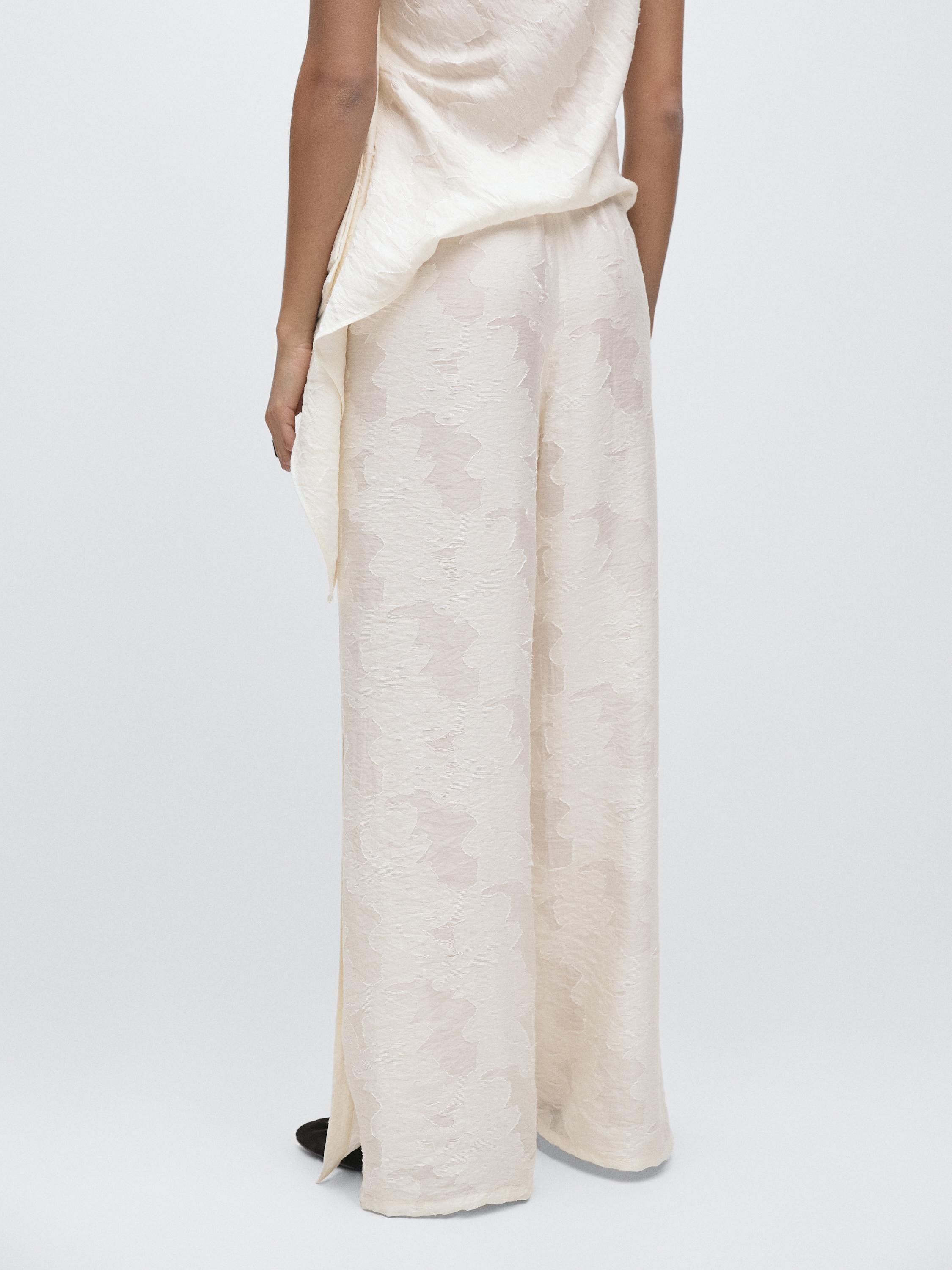 Flowing stretch trousers with fabric detail